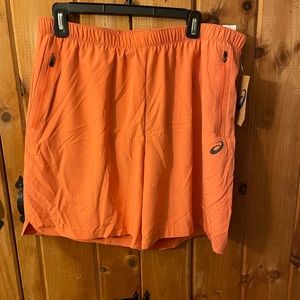 Orange lined shorts by Asics.